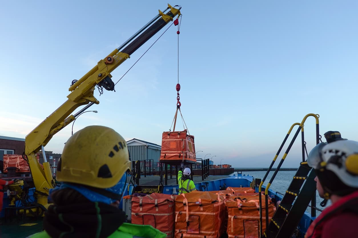 Crane lifting a load — compliant lifting operation in progress