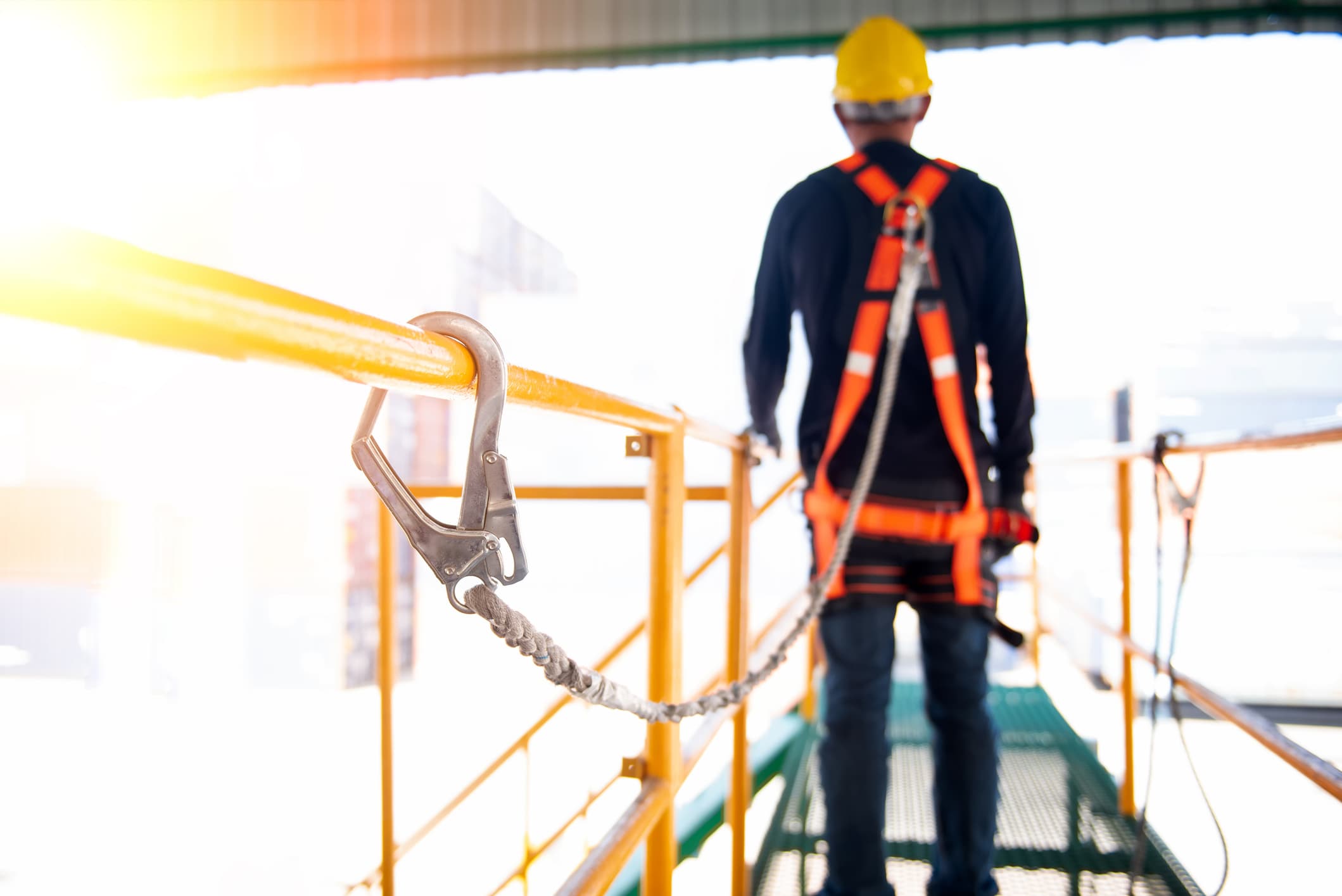 Worker with fall protection equipment on elevated platform